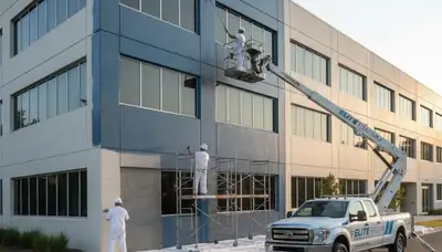 Professional commercial painters finishing office exterior in Colorado Springs, CO